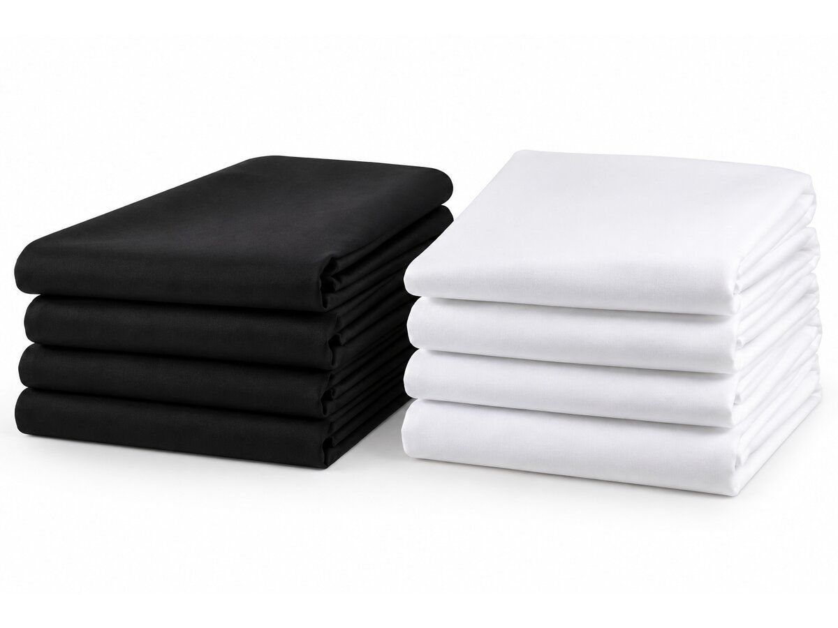 Folded stacks of black and white tablecloths